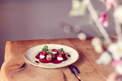 a plate of food on a wooden table at The Tavern at Hale in Milnthorpe