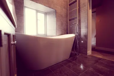 a white bath tub in a bathroom with a window at The Tavern at Hale in Milnthorpe