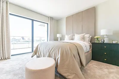 a bedroom with a large bed with a large window at NOVU Apartments Liverpool Waterfront in Liverpool