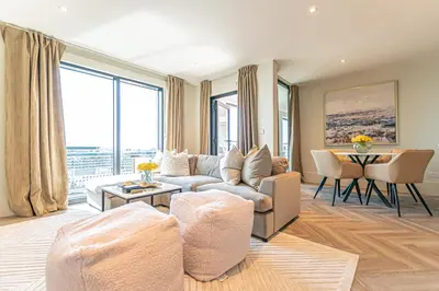 a living room with a couch and a table at NOVU Apartments Liverpool Waterfront in Liverpool