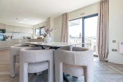 a kitchen and dining room with a table and chairs at NOVU Apartments Liverpool Waterfront in Liverpool