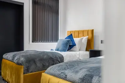 a bedroom with two beds and a window at Winter Garden Apartments by Sasco in Blackpool