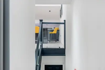 a balcony with yellow chairs in a building at Winter Garden Apartments by Sasco in Blackpool