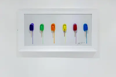 a white frame with a row of colorful lollipops at Winter Garden Apartments by Sasco in Blackpool
