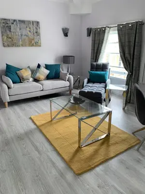 a living room with a couch and a table at Winckley Square Residences in Preston
