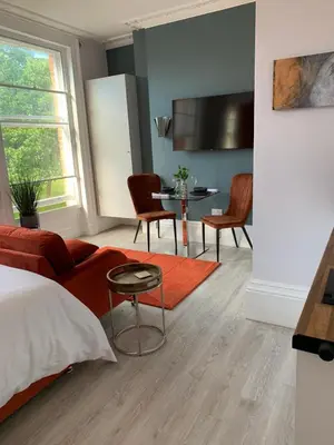 a living room with a couch and a table at Winckley Square Residences in Preston