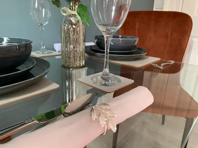 a dining room table with plates and glasses on it at Winckley Square Residences in Preston