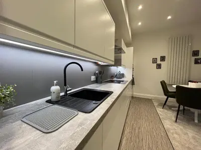a kitchen with a sink and a counter top at Winckley Square Residences in Preston