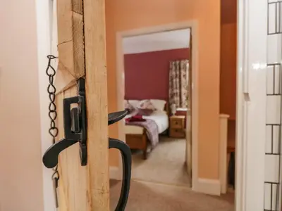 a door to a room with a bedroom at Mount Pleasant Cottage in Grange Over Sands