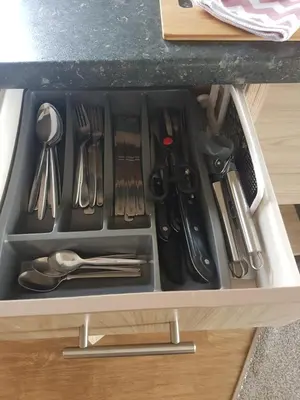 a drawer filled with utensils in a cabinet at KINGDOM HOLIDAY PARK in Haverigg
