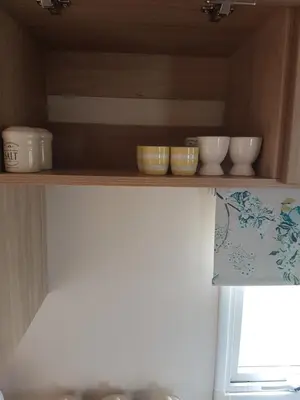 a shelf with bowls and other items on it at KINGDOM HOLIDAY PARK in Haverigg