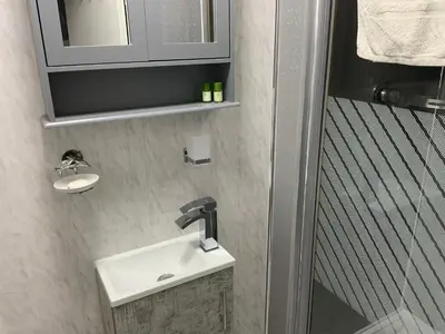 a bathroom with a sink and a mirror at The Glenroy Guest House in Blackpool