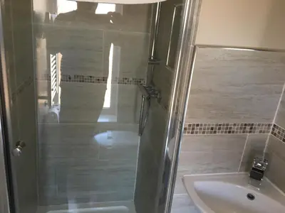 a bathroom with a shower and a sink at The Glenroy Guest House in Blackpool