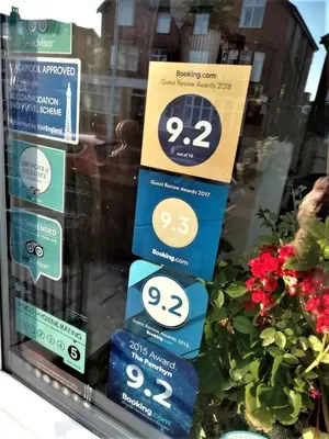a display of signs in a window with flowers at The Penrhyn in Blackpool