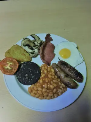 a plate of breakfast food with eggs beans and bacon at The Penrhyn in Blackpool