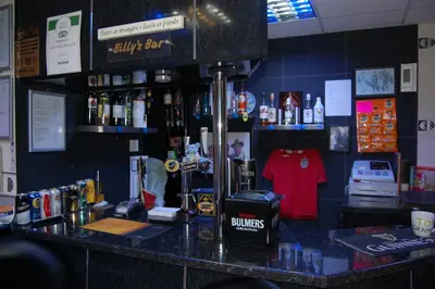 a bar in a restaurant with a counter with alcohol at The Penrhyn in Blackpool