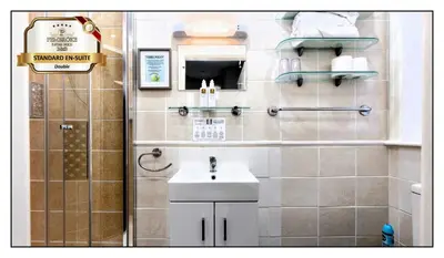 a small bathroom with a sink and a shower at Pembroke Hotel in Blackpool