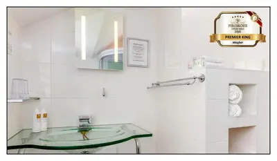a white bathroom with a sink and a mirror at Pembroke Hotel in Blackpool
