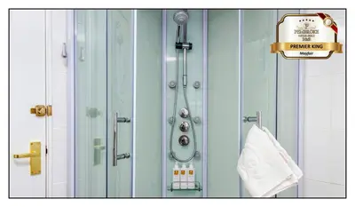 a shower in a bathroom with a towel at Pembroke Hotel in Blackpool