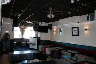 a dining room with tables and a ceiling fan at The Blenheim Mount Hotel in Blackpool