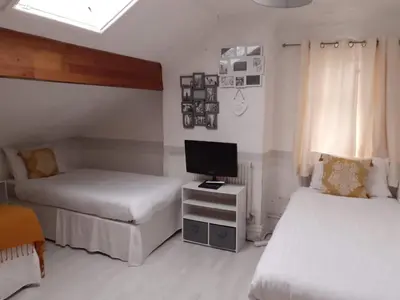 a bedroom with two beds and a tv on a table at Vista Sol in Blackpool
