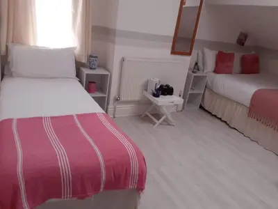 a hotel room with two beds and a window at Vista Sol in Blackpool