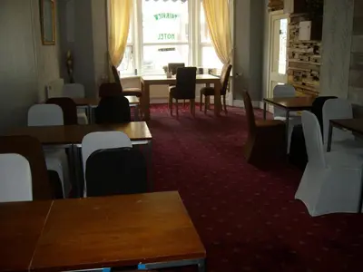 a dining room with tables and chairs and a window at Vista Sol in Blackpool