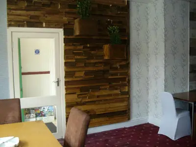a dining room with a wall made out of wood at Vista Sol in Blackpool