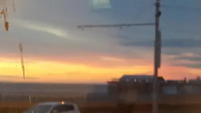 a car is parked in front of a sunset at Lynwood Hotel in Blackpool