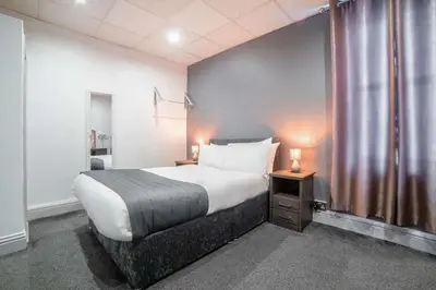 a hotel room with a bed and a window at Comfort Inn Blackpool Gresham in Blackpool