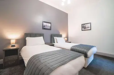 a hotel room with two beds and two lamps at Comfort Inn Blackpool Gresham in Blackpool