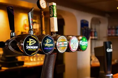 a row of cups on a rack in a bar at Comfort Inn Blackpool Gresham in Blackpool