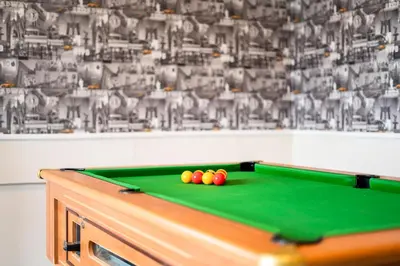 a pool table with three balls on top of it at Comfort Inn Blackpool Gresham in Blackpool