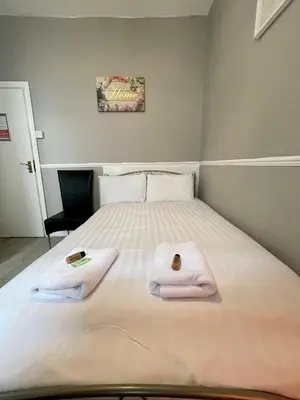 a bedroom with two towels on a bed at Topaz Blackpool in Blackpool