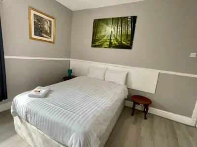 a small bedroom with a bed and a picture on the wall at Topaz Blackpool in Blackpool