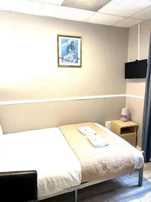 a bedroom with a bed and a picture on the wall at Topaz Blackpool in Blackpool