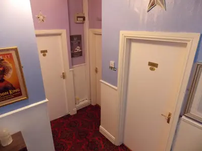 a hallway with two doors and a red carpet at Topaz Blackpool in Blackpool