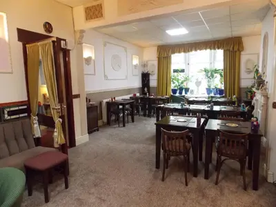 a dining room with tables and chairs and a room with at Topaz Blackpool in Blackpool