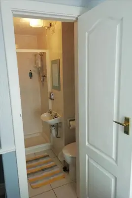 a bathroom with a sink and a tub and a toilet at Shirley Heights Hotel in Blackpool