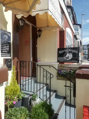 an entrance to a building with stairs and flowers at Shirley Heights Hotel in Blackpool