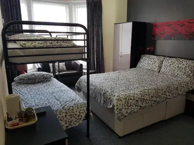 a bedroom with two bunk beds and a window at Langroyd Hotel in Blackpool