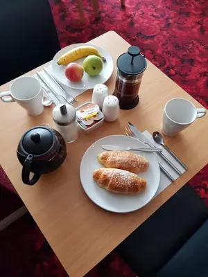 a wooden table with plates of food on it at Langroyd Hotel in Blackpool