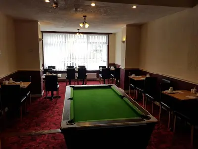 a pool table in a restaurant with tables and chairs at Langroyd Hotel in Blackpool