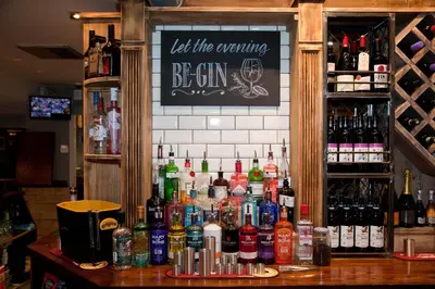 a bar with a lot of bottles of alcohol at The Royal Hotel in Bolton le Sands