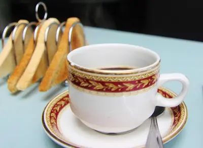 a cup of coffee on a plate on a table at The Hollingworth in Lytham St Annes