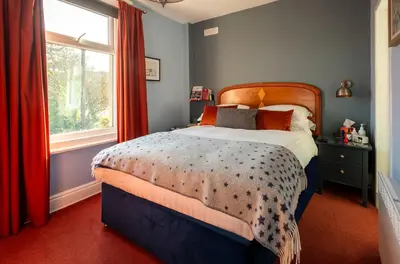 a bedroom with a bed and a window at The Broadwater Guest House in Morecambe
