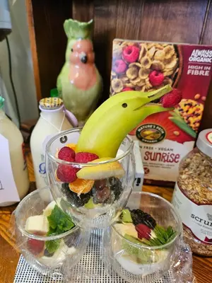 a glass bowl filled with fruit and a banana on a table at The Broadwater Guest House in Morecambe