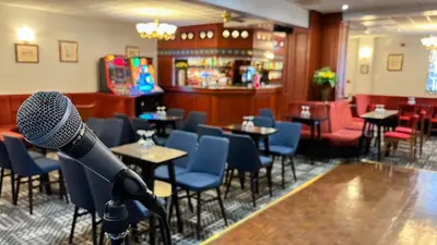 a microphone in a restaurant with tables and chairs at Sutcliffe Hotel in Blackpool