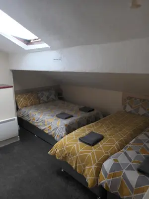 a room with two beds in a room at Strides Hotel in Blackpool