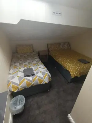 two beds in a small room with at Strides Hotel in Blackpool